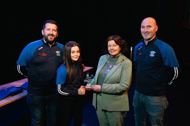 Derry City & Strabane District Council Mayor Patricia Logue with coaches Chris McDaid, John Roulston, and captain Kayla Doherty, whose under-11 side won the League and Summer Cup. 