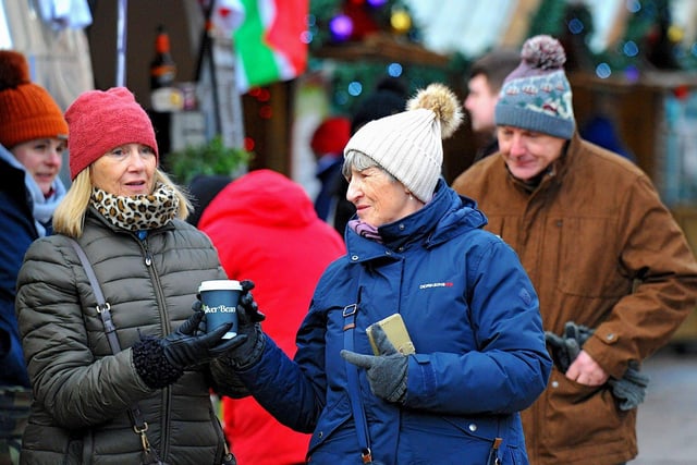 People visiting the Christmas Market in Guildhall Square on Friday afternoon. Photo: George Sweeney. DER2250GS – 67