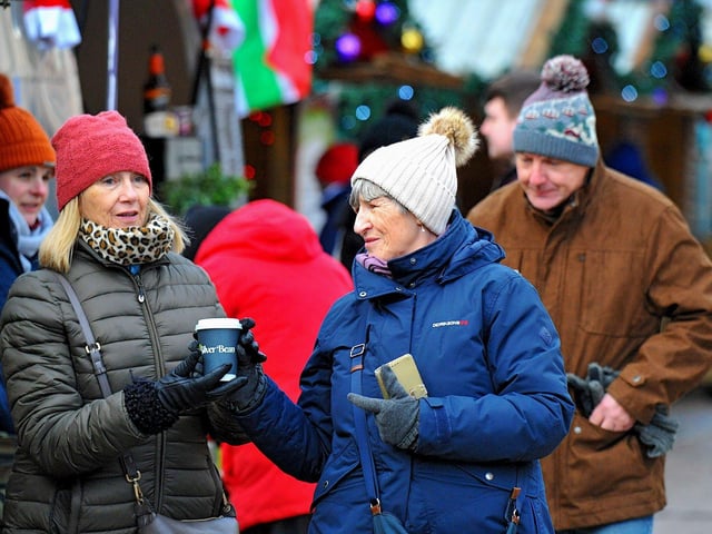 People visiting the Christmas Market in Guildhall Square on Friday afternoon. Photo: George Sweeney. DER2250GS – 67