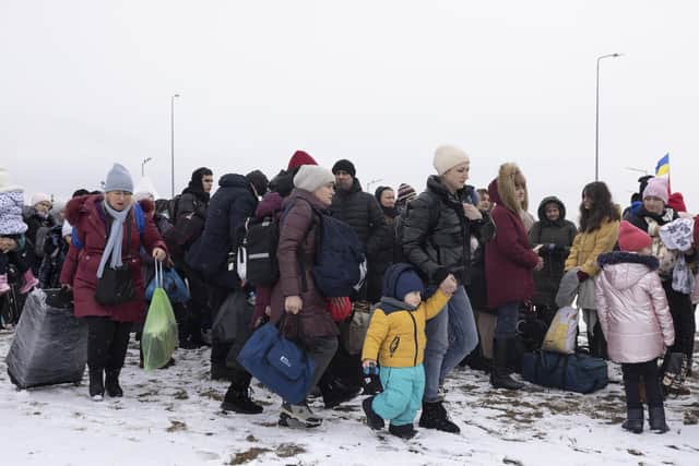 Refugees fleeing conflict make their way to the Krakovets border crossing with Poland on March 09, 2022 in Krakovets, Ukraine. More than a million people have fled Ukraine following Russia's large-scale assault on the country, with hundreds of thousands of Ukrainians passing through Lviv on their way to Poland. (Photo by Dan Kitwood/Getty Images)