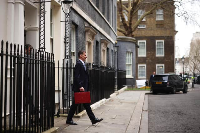 LONDON, ENGLAND - MARCH 15: UK Chancellor Jeremy Hunt leaves Downing Street with the despatch box to present his spring budget to parliament on March 15, 2023 in London, England. Highlights of the 2023 budget are an increase in the tax-free allowance for pensions which the Chancellor hopes will stem the number of people taking retirement, a package of help for swimming pools affected by the increase in energy bills and changes to childcare support for parents on universal credit. (Photo by Dan Kitwood/Getty Images)