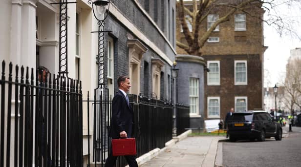 LONDON, ENGLAND - MARCH 15: UK Chancellor Jeremy Hunt leaves Downing Street with the despatch box to present his spring budget to parliament on March 15, 2023 in London, England. Highlights of the 2023 budget are an increase in the tax-free allowance for pensions which the Chancellor hopes will stem the number of people taking retirement, a package of help for swimming pools affected by the increase in energy bills and changes to childcare support for parents on universal credit. (Photo by Dan Kitwood/Getty Images)