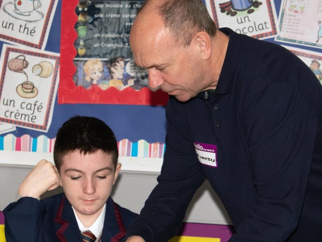 Mr. Watters helping Year 8 student Mason understand his school timetable at Oakgrove on Monday. : Oakgrove Integrated College welcomes latest influx of Year 8 pupils