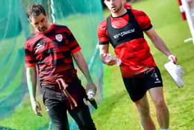 A WORD IN YOUR EAR . . . Adam O'Reilly walking alongside manager Tiernan Lynch at training this week. Photograph by Kevin Morrison.