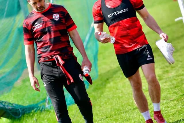A WORD IN YOUR EAR . . . Adam O'Reilly walking alongside manager Tiernan Lynch at training this week. Photograph by Kevin Morrison.