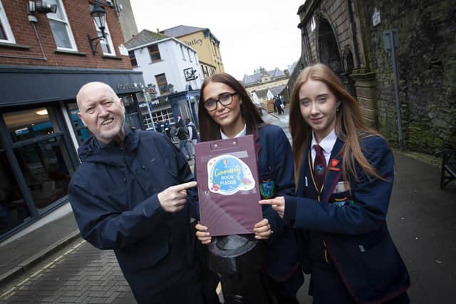 Well known local author and playwright Dave Duggan endorsing the Community Book Pledge with Oakgrove Integrated College.