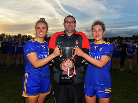 Steelstown joint captains Ciara McGurk and Aoife McGough receive the Senior Championship trophy from Sean Hamill on Saturday afternoon.  Photo: George Sweeney