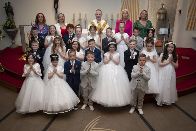 Pupils from Mrs. Tina Ruddy class at St. Brigid’s Primary School, Carnhill who received the Sacrament of First Holy Communion on Wednesday afternoon last at St. Brigid’s Church. Included back from left are Mrs. Tina Ruddy, Ms. Sally Ó Neill, Fr Sean O’Donnell, Ms. Mary McCallion, Principal and Ms. Gemma Carruthers. (Photos: Jim McCafferty Photography)