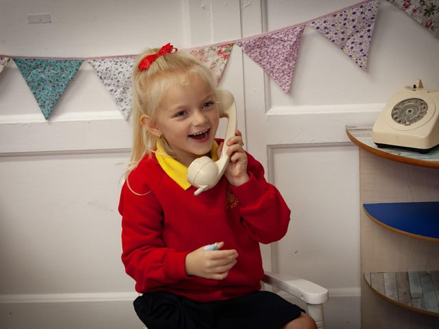 Amaya 'phones' home from Steelstown PS on Wednesday to let mum know she's ok. (Photos: Jim McCafferty Photography):.