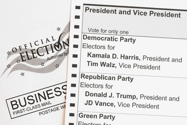 In this photo illustration, an absentee voter mail-in ballot shows the names of the presidential and vice presidential candidates for the November 5 US general election, including Democratic party candidates US Vice President Kamala Harris and her running mate, Minnesota Governor Tim Walz, and Republican party candidate former US President Donald Trump and his running mate, Ohio Senator J.D. Vance, on September 25, 2024 in Arlington, Virginia. . (Photo by SAUL LOEB / AFP) (Photo by SAUL LOEB/AFP via Getty Images)