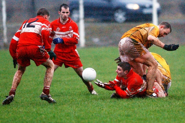 Derry's Conleth Moran lays the ball off under pressure to Conan O'Brien as Padraig Kelly closes in during The McKenna Cup tie at Glen in January 2004.