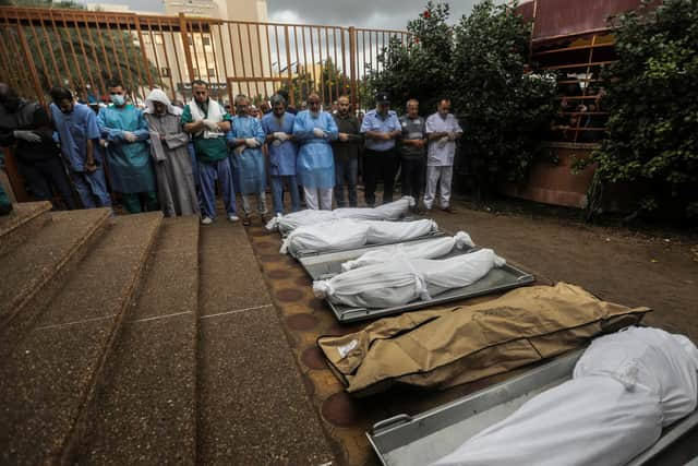 People mourn as they collect the bodies of Palestinians killed in Israeli raids on November 14, 2023 in Khan Yunis, Gaza. (Photo by Ahmad Hasaballah/Getty Images)