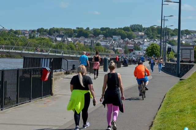 People exercise, in the sunshine, along the Foyle Embankment in Derry (File picture). DER2220GS - 012