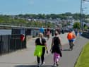 People exercise, in the sunshine, along the Foyle Embankment in Derry (File picture). DER2220GS - 012
