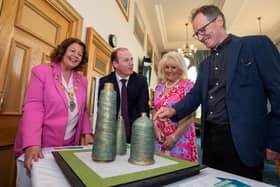 Communities Minister Gordon Lyons is pictured looking at the plans for the Factory Girls Sculpture in Derry with (L-R) Mayor of Derry City and Strabane District Council, Patricia Logue, Factory Girls representative Mary White and artist Chris Wilson.
