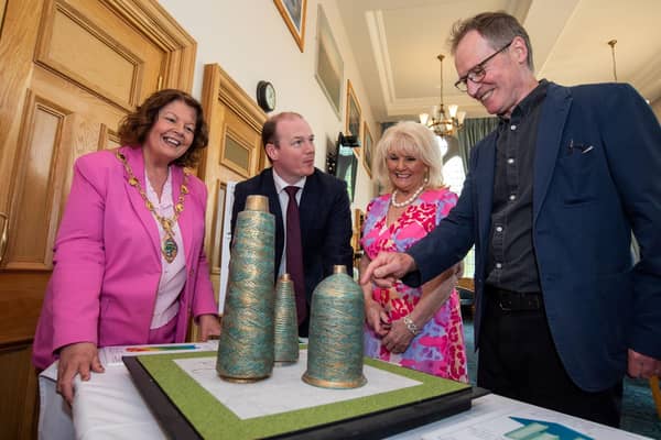Communities Minister Gordon Lyons is pictured looking at the plans for the Factory Girls Sculpture in Derry with (L-R) Mayor of Derry City and Strabane District Council, Patricia Logue, Factory Girls representative Mary White and artist Chris Wilson.