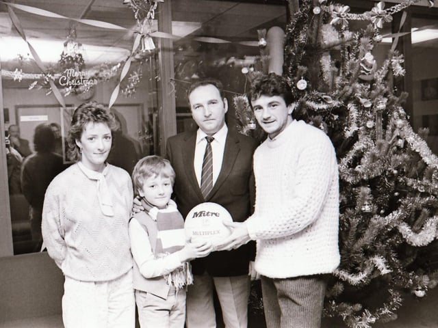 Noel King presents an autographed ball at Radio Foyle.