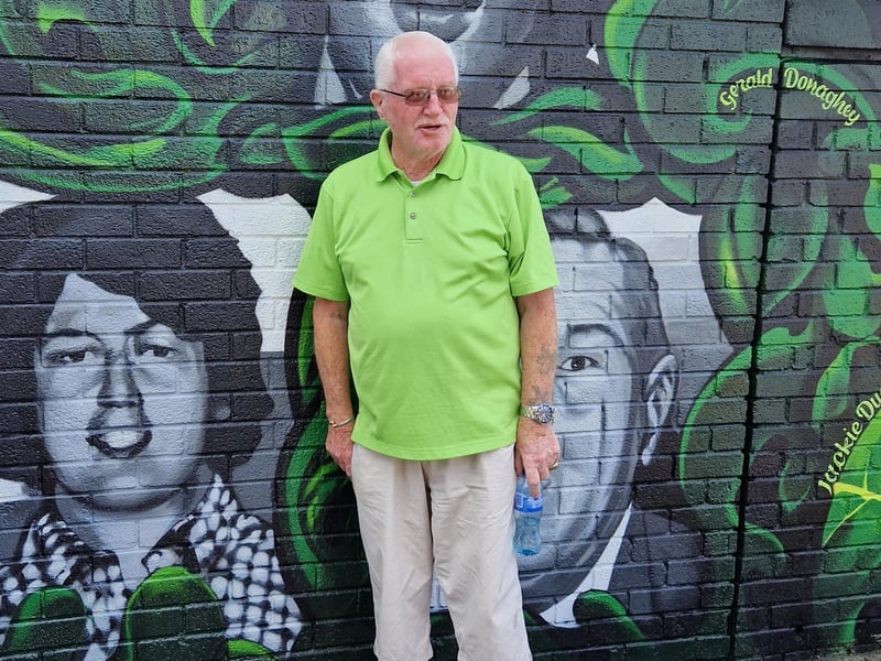 Leo Young pictured alongside a portrait of his younger brother John.