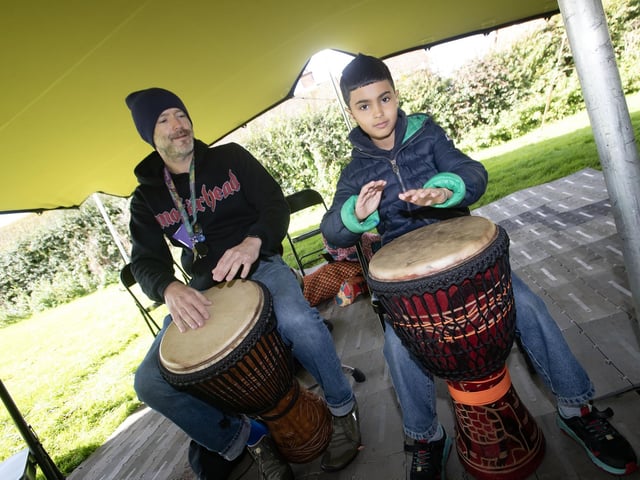 Behrad Heydiri (9) showing off his drumming skills under the guidance of Philip Wallace during Saturday's 'Waterside Together' - A Shared Spaces Mini Festival, held at Woodburn Urban Park. (Photos: Jim McCafferty Photography) : .