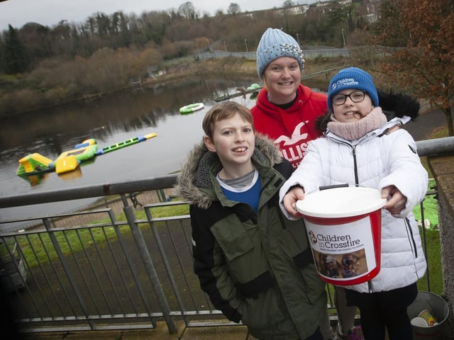 St. Joseph’s Boys School teacher Fiona Page pictured with her children Kitty (10) and Peter (9), supporting her pier jump for Children in Crossfire on Saturday last the Creggan Reservoir.