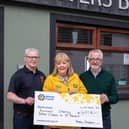 Paddy handing over the cheque outside McKeever's. (Photo Shea Deighan)