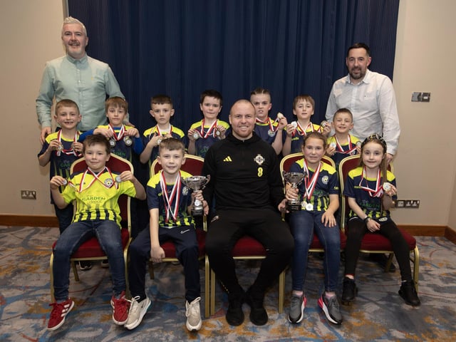 Ronan O'Donnell, Irish Football Association, special guest at the D&D Youth FA Annual Awards at the City Hotel on Friday night presents Sion Swifts Hawks U8s with the Summer Plate and Winter Cup. Included are coaches Jonny Forbes and Paul Gallagher.