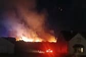 The fire came close to homes.