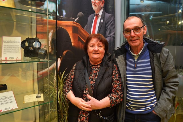 Rosemary Doyle pictured beside a gasmask she wore on Bloody Sunday and which protected her when she was hit by a rubber bullet on display at the Order of Malta Exhibition launch in the Museum of Free Derry on Monday evening last Included in the photograph is Liam Wray. Photo: George Sweeney. DER2305GS – 54