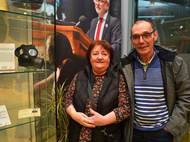 Rosemary Doyle pictured beside a gasmask she wore on Bloody Sunday and which protected her when she was hit by a rubber bullet on display at the Order of Malta Exhibition launch in the Museum of Free Derry on Monday evening last Included in the photograph is Liam Wray. Photo: George Sweeney. DER2305GS – 54