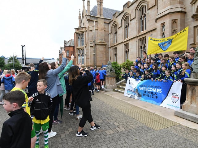 Parents take photographs of the Gleneely team who prepare to set off on the parade through the city.