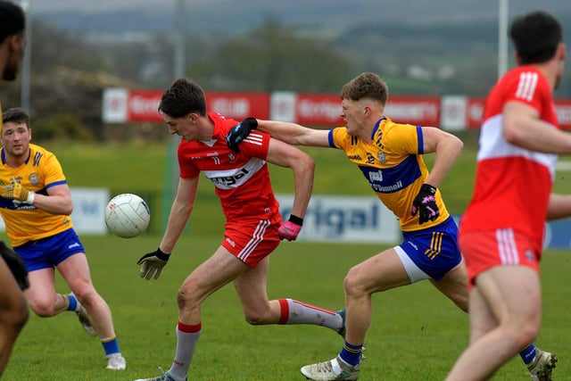 Derry’s Paul Cassidy is challenged by Clare’s Dermot Coughlan at Owenbeg on Sunday afternoon. Photo: George Sweeney. DER2312GS – 02