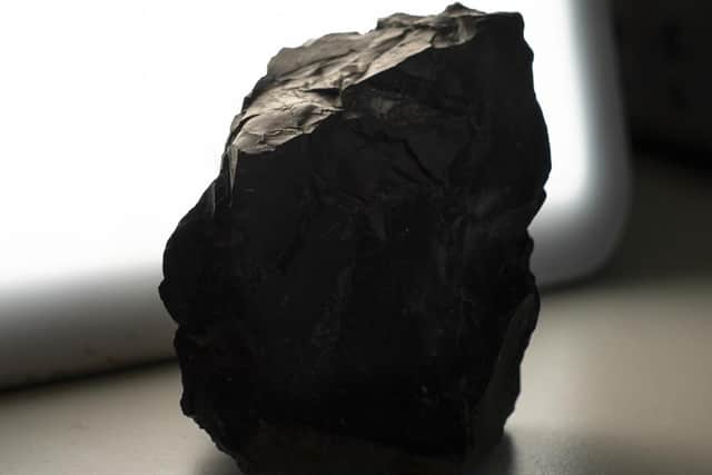 A handsome block of black obsidian originally discovered at Sandy Braes in South Derry figures.