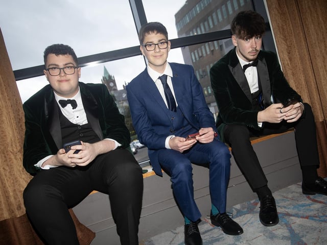 ON THE PHONES!. . . . St. Joseph's Boys School formal students Dara Doherty, Paddy Quigg and Matthew Doherty on their phones at Friday night's formal in the City Hotel.