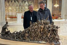 Archbishop Eamon Martin welcomes the arrival to Armagh Cathedral of a 6ft model of the human trafficking sculpture by Tim Schmalz 'Let the Oppressed Go Free'