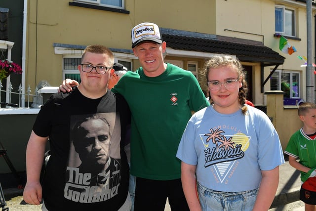 Nathan and Seanan pictured with James McClean at a street party held in Creggan Heights, on Saturday afternoon, to celebrate James winning his 100th international cap for the Republic of Ireland. Photo: George Sweeney. DER2325GS - 102