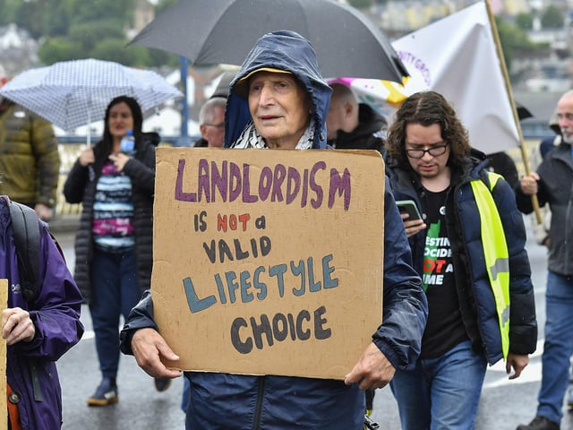 Participants carry placards during the Derry Housing Action Committee protest march over housing crisis on Saturday afternoon Photo: George Sweeney