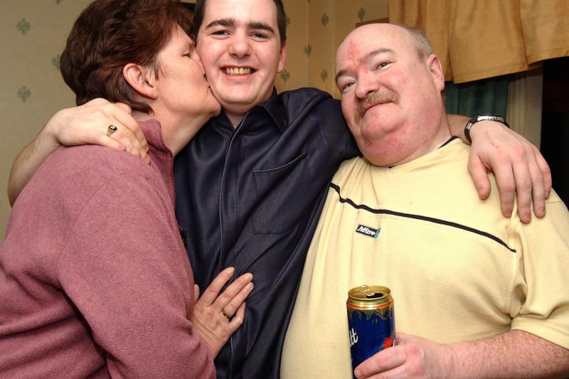 Kevin gets a big kiss from his mum Anne and his Dad Michael on his 21st birthday. 