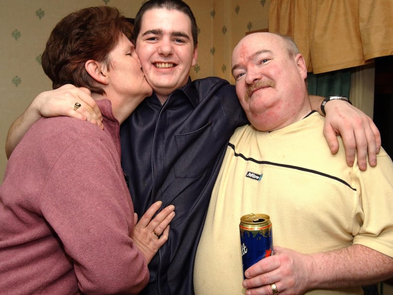 Kevin gets a big kiss from his mum Anne and his Dad Michael on his 21st birthday.