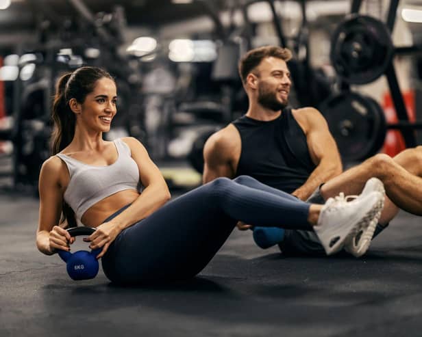 Man and woman working out in a gym.