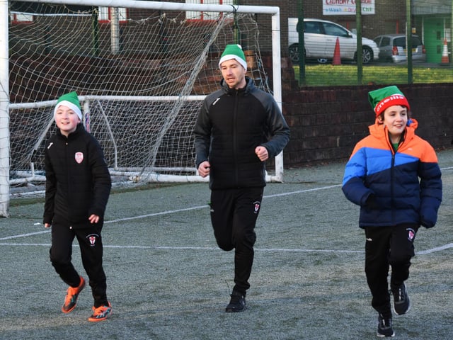 Benjamin, Mr Quigley and Luka taking part in the Manchester United Foundation's Santa's Run at Magee College on Tuesday morning.