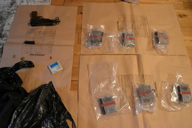 A machine pistol, improvised explosive devices and ammunition seized by police on Friday.