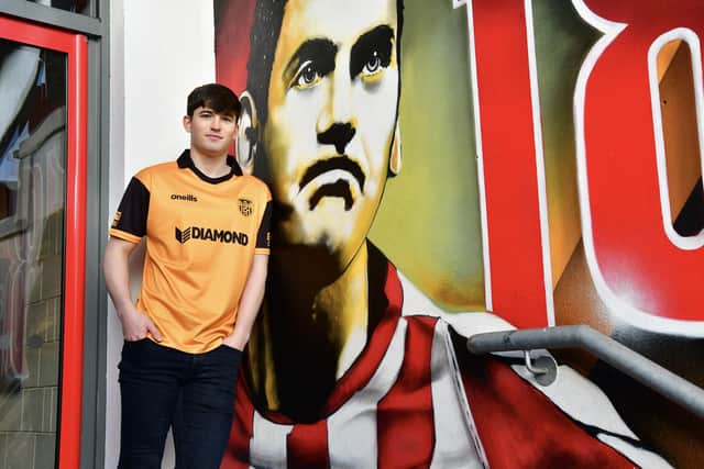 Colm Whelan pictured beside the Mark Farren mural at the Ryan McBride Brandywell.