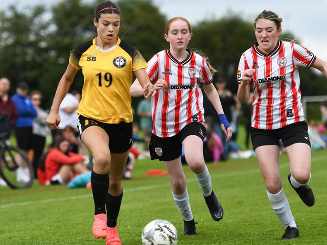 Gundo FC forward Brooke Immel races past Derry City Ladies under-15's defenders Emily Duffy and Katy Mooney.