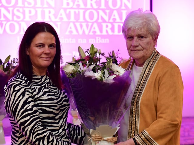 Kathleen McCallion receiving her presentation from Aine Doherty, daughter of Roisin Barton.