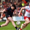 Armagh's Callum O'Neill charges between Derry duo Conro Glas and Ethan Doherty.