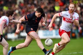 Armagh's Callum O'Neill charges between Derry duo Conro Glas and Ethan Doherty.