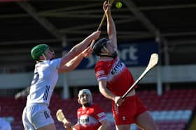 Derry’s Meehaul McGrath gets the sliothar ahead of Kildare’s Paul Dolan. Photo:  George Sweeney