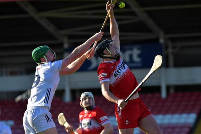 Derry’s Meehaul McGrath gets the sliothar ahead of Kildare’s Paul Dolan. Photo: George Sweeney