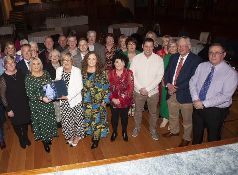 The Mayor, Sandra Duffy making a special presentation to former Hollybush PS Principal Carmel Dunn on her retirement from the school and to mark her overall contribution to education at a function in her honour at the Guildhall on Wednesday evening. Included are family, friends and former board of governors, teaching and ancillary staff from Hollybush Primary School.