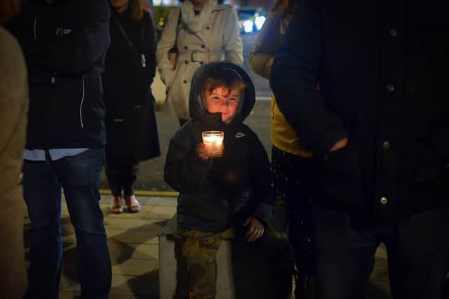 A young boy carries a lighted candle at a vigil, held in Guildhall Square on Monday evening, to remember those who died in the Creeslough tragedy on Friday afternoon last. Photo: George Sweeney. DER2241GS – 51